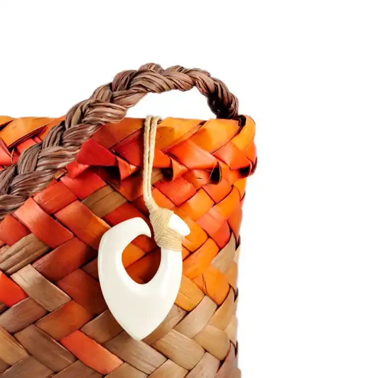 Māori bone carving with traditional binding