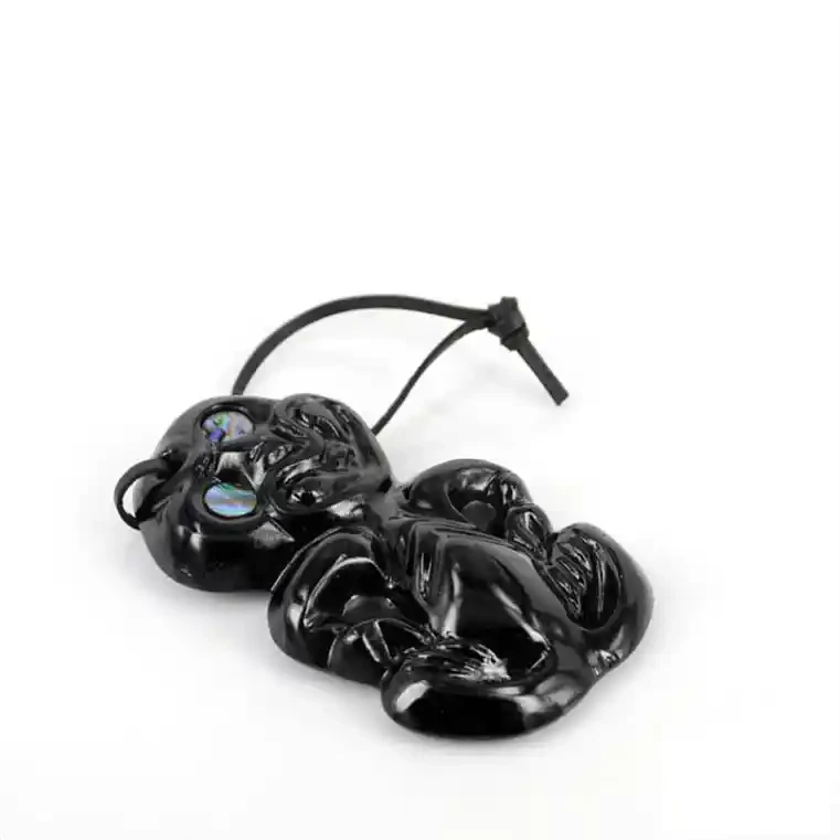 Glass tiki. Glass Māori tiki, shiny finish