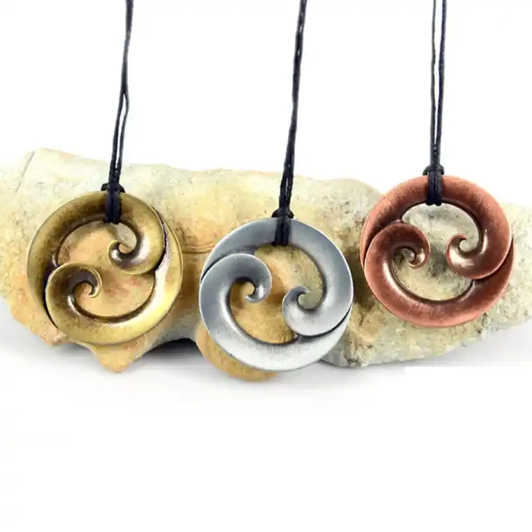 Round double koru zinc pendants