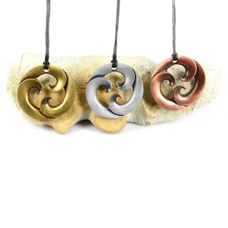 Triple koru zinc pendants.