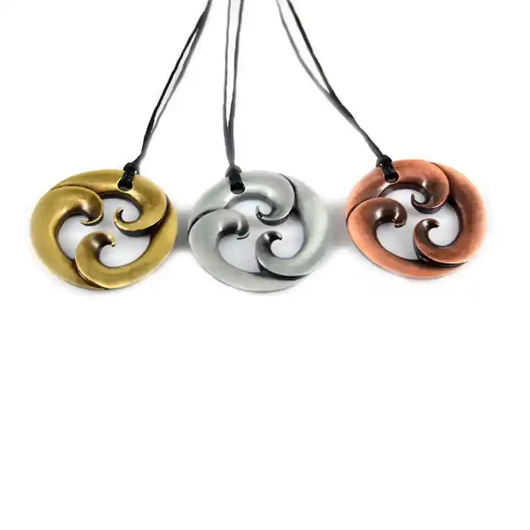 Triple koru zinc pendants.